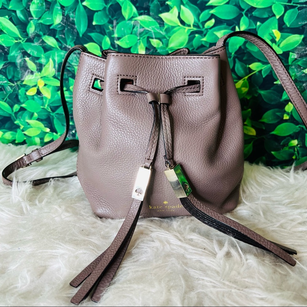 Kate spade small grayish crossbody drwastring style casual bag / purse .